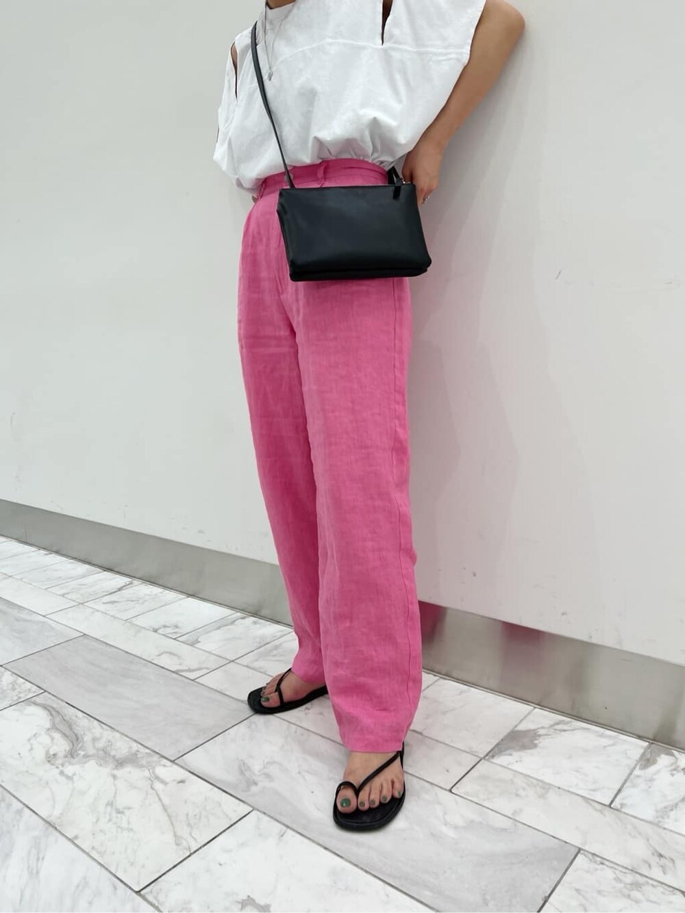 ブラック系のサンダル、ブラック系のショルダーバッグ、ホワイト系のTシャツ/カットソーを着用したレディースの春コーディネートの5枚目の写真