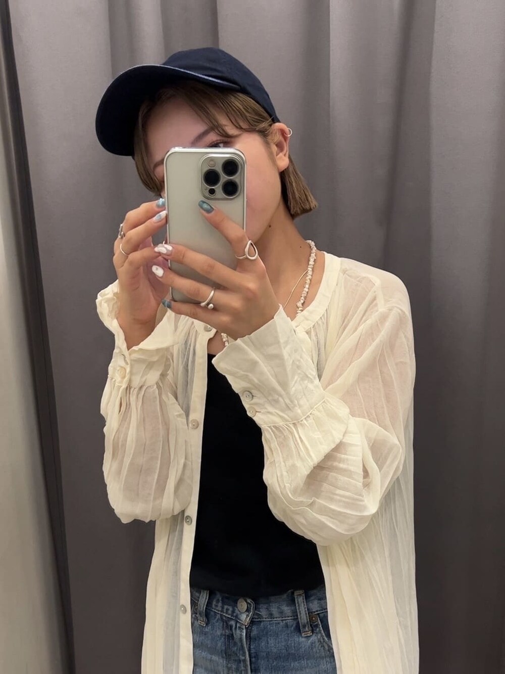 ブルー系のデニムパンツ、グリーン系のサンダル、ブラック系のキャミソールを着用したレディースの夏コーディネートの9枚目の写真