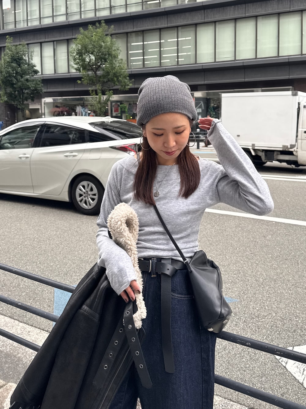 グレー系のニット/セーター、ブルー系のデニムパンツ、グレー系のニットキャップ/ビーニーを着用したレディースの秋コーディネートの9枚目の写真