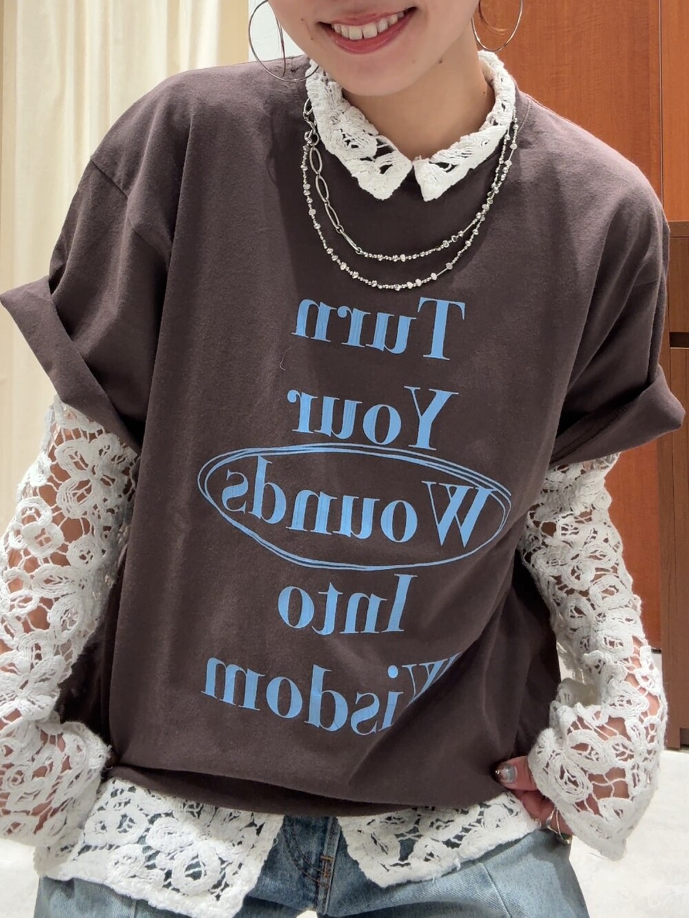 ブルー系のデニムパンツ、ブラウン系のTシャツ/カットソー、ホワイト系のシャツ/ブラウスを着用したレディースの春コーディネートの9枚目の写真