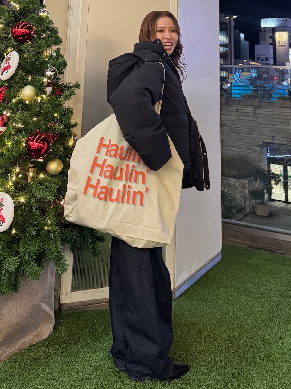 グレー系のカーディガン/ボレロ、ブラック系のダウンジャケット/コート、ホワイト系のトートバッグを着用したレディースの冬コーディネートの2枚目の写真