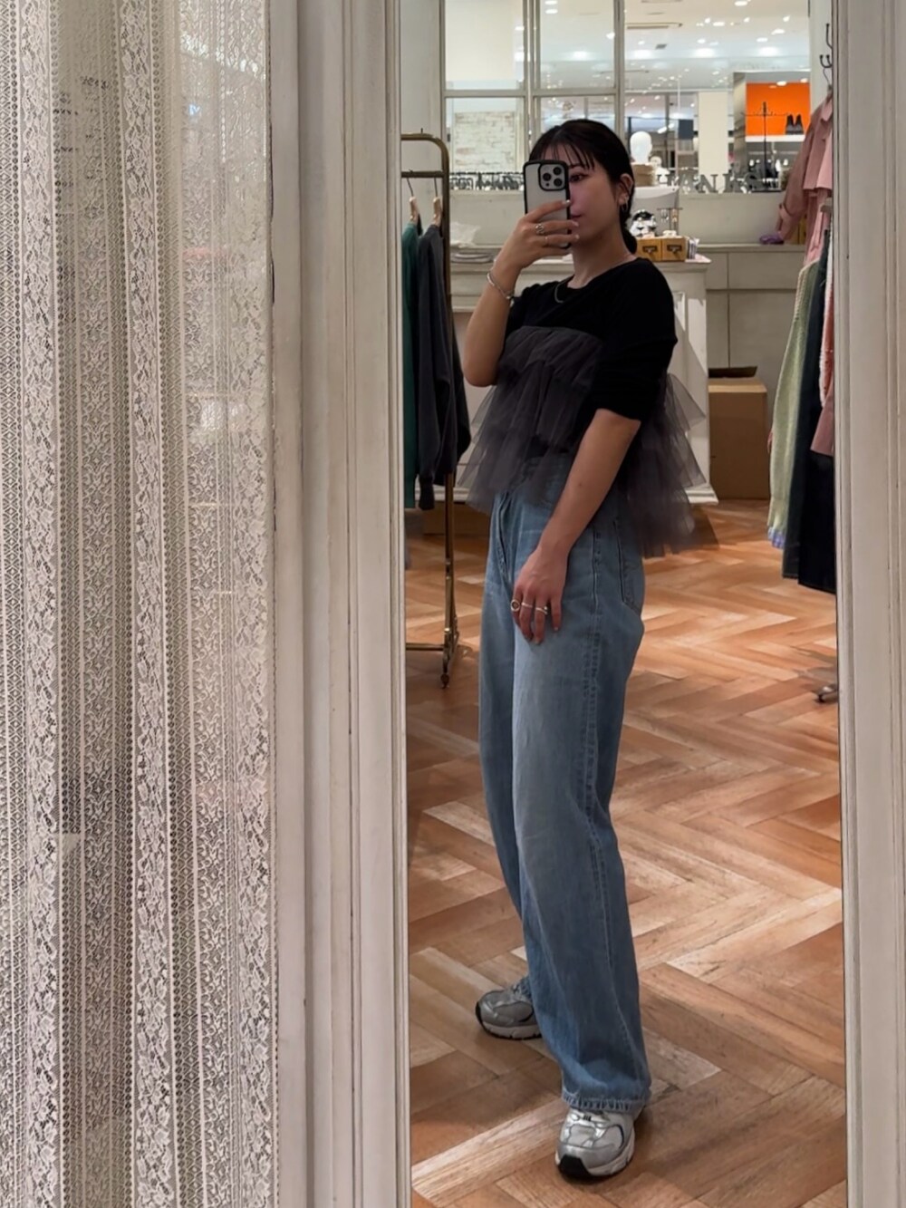 ブラック系のTシャツ/カットソー、グレー系のベスト、ブルー系のデニムパンツを着用したレディースの冬コーディネートの7枚目の写真