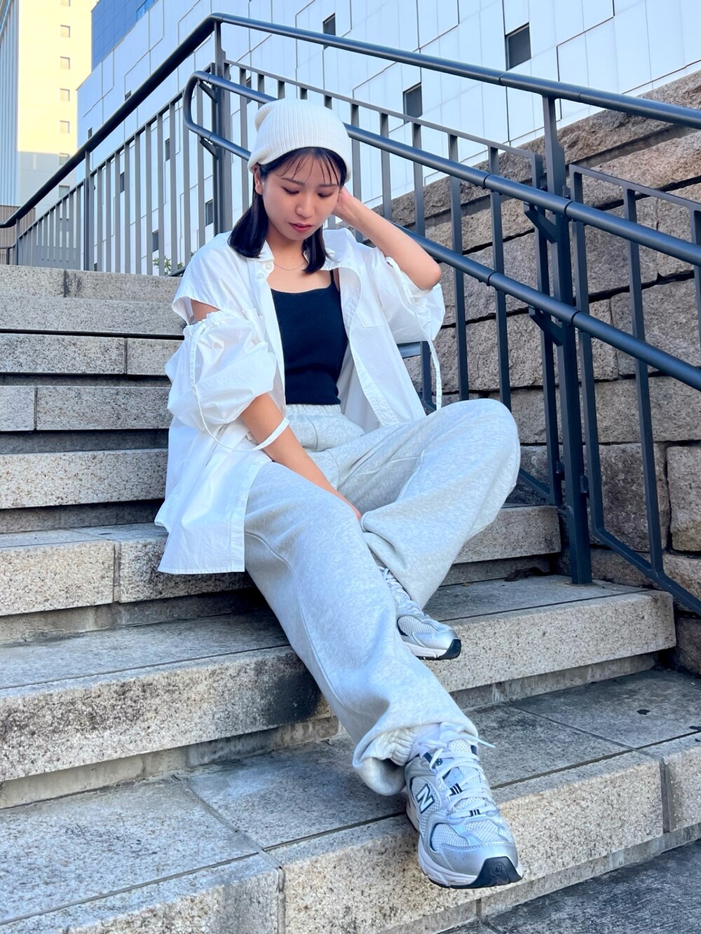 グレー系のスウェットパンツ、ホワイト系のシャツ/ブラウス、ブラック系のキャミソールを着用したレディースの秋コーディネートの2枚目の写真