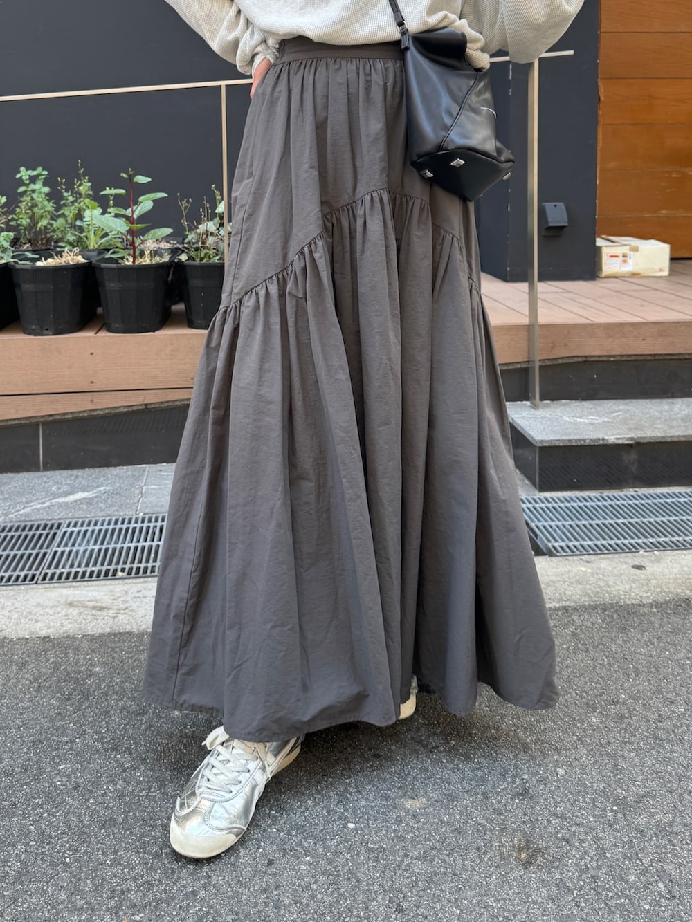 グレー系のスカート、ホワイト系のTシャツ/カットソー、ブルー系のキャップを着用したレディースの夏コーディネートの7枚目の写真