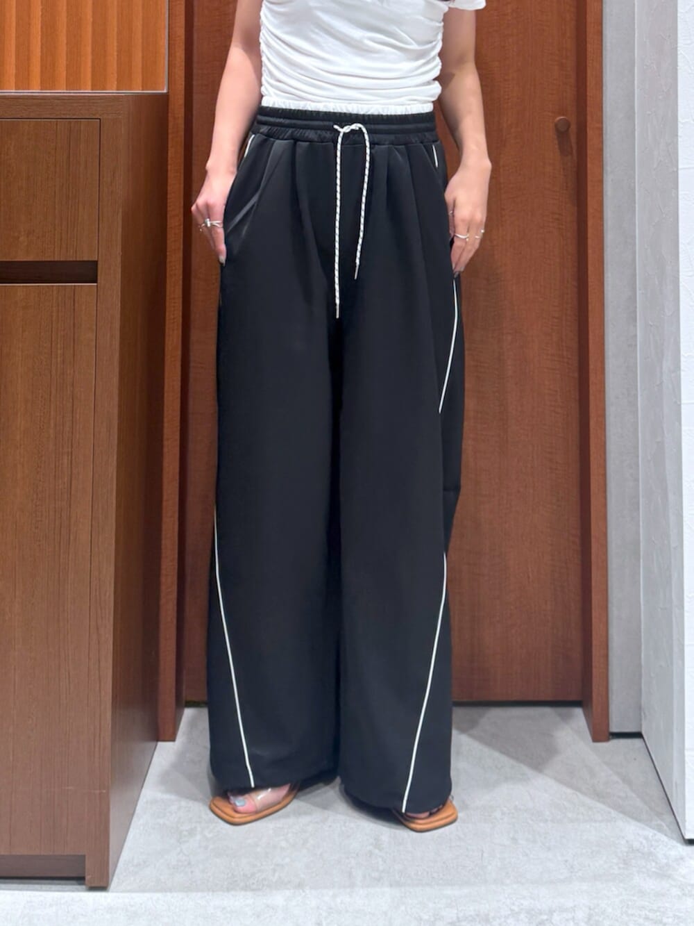 ブラック系のその他パンツ、ホワイト系のTシャツ/カットソー、グレー系のサングラスを着用したレディースの夏コーディネートの6枚目の写真