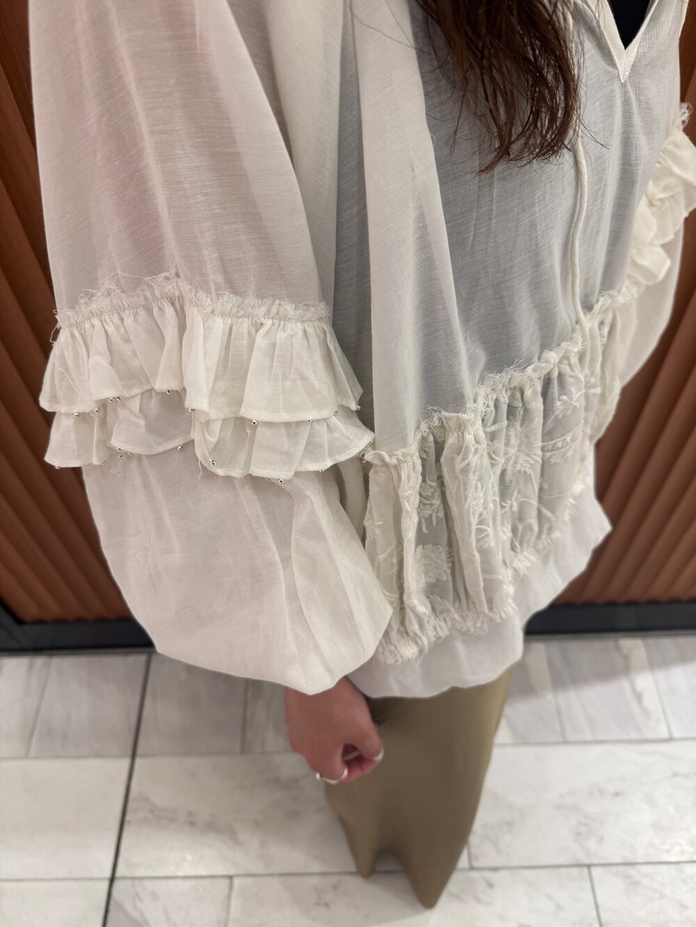 ベージュ系のスカート、ホワイト系のシャツ/ブラウス、ブラック系のキャミソールを着用したレディースの春コーディネートの8枚目の写真