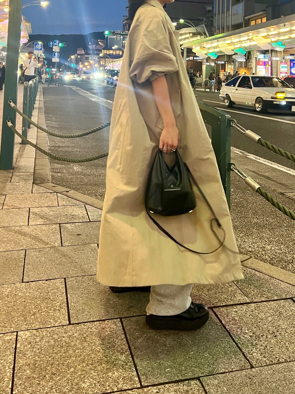 グレー系のその他パンツ、ベージュ系のステンカラーコートを着用したレディースの秋コーディネートの4枚目の写真