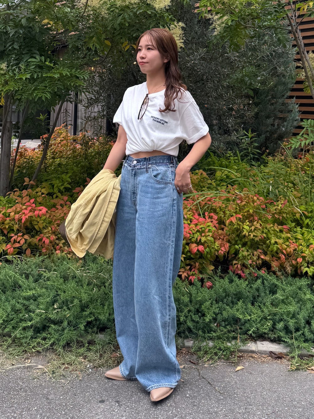 ブルー系のデニムパンツ、イエロー系のブルゾン、ホワイト系のTシャツ/カットソーを着用したレディースの夏コーディネートの7枚目の写真