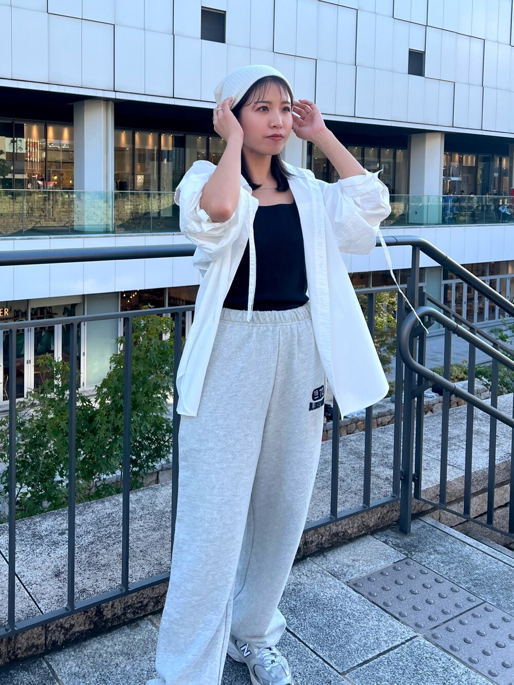 グレー系のスウェットパンツ、ホワイト系のシャツ/ブラウス、ブラック系のキャミソールを着用したレディースの秋コーディネートの3枚目の写真