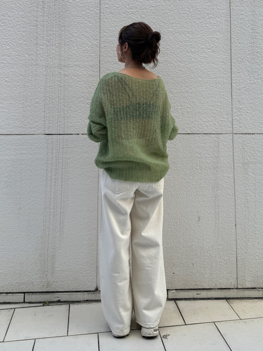 ホワイト系のデニムパンツ、グリーン系のニット/セーターを着用したレディースの秋コーディネートの4枚目の写真