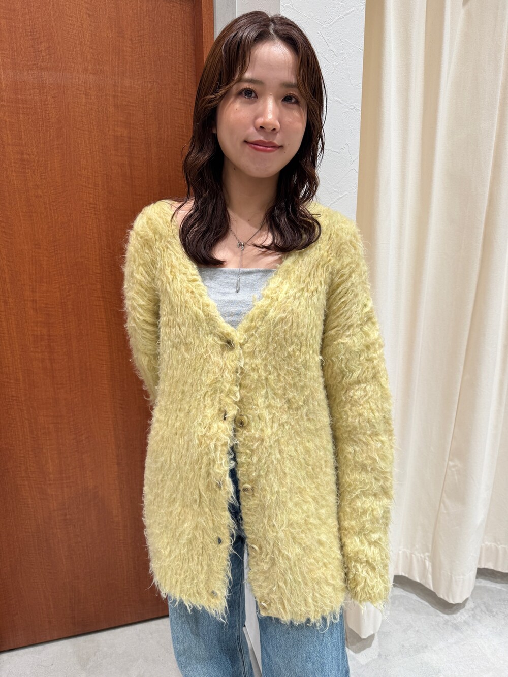 ブルー系のデニムパンツ、イエロー系のカーディガン/ボレロを着用したレディースの秋コーディネートの8枚目の写真