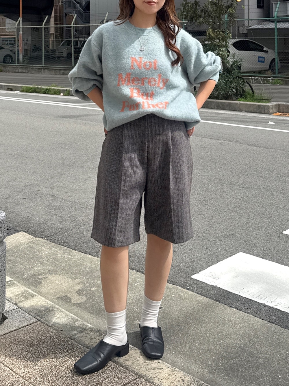 グレー系のその他パンツ、ブラック系のサンダル、グリーン系のニット/セーターを着用したレディースの秋コーディネートの2枚目の写真