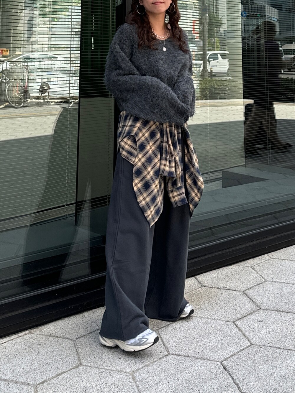 グレー系のスウェットパンツ、ブルー系のシャツ/ブラウス、グレー系のニット/セーターを着用したレディースの秋コーディネートの5枚目の写真