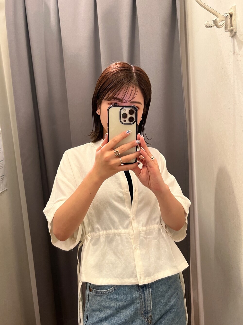ブルー系のデニムパンツ、ホワイト系のサンダル、ホワイト系のシャツ/ブラウスを着用したレディースの春コーディネートの5枚目の写真