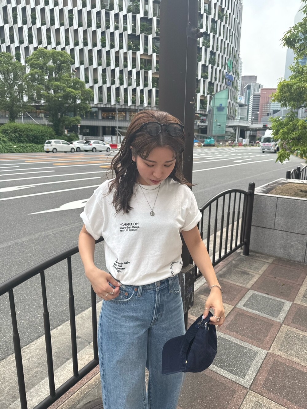 ホワイト系のTシャツ/カットソー、ブルー系のデニムパンツを着用したレディースの夏コーディネートの5枚目の写真