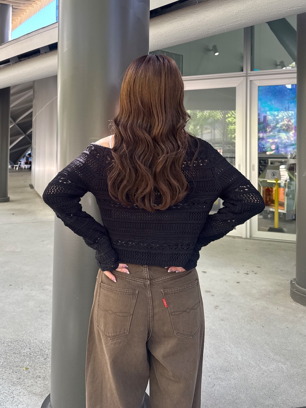 ブラウン系のデニムパンツ、ブラック系のその他シューズ、ブラック系のニット/セーターを着用したレディースの秋コーディネートの8枚目の写真