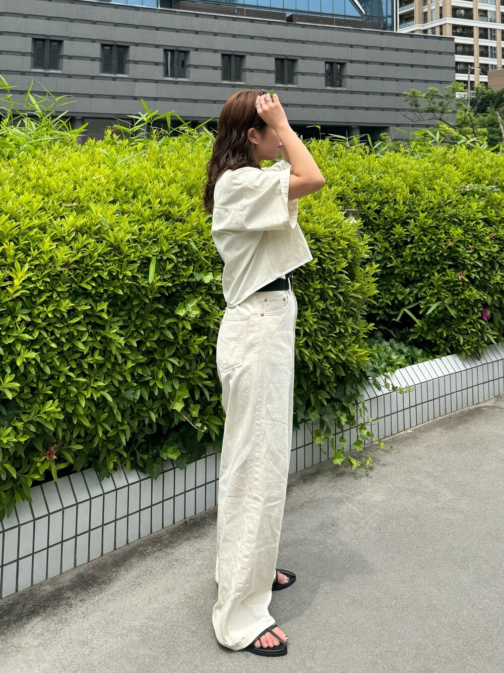 ホワイト系のシャツ/ブラウス、ホワイト系のデニムパンツ、グレー系のTシャツ/カットソーを着用したレディースの春コーディネートの3枚目の写真