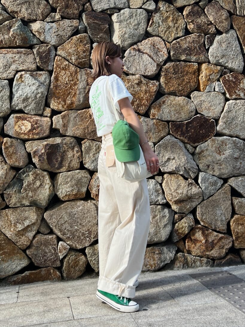 ホワイト系のデニムパンツ、ホワイト系のTシャツ/カットソー、グリーン系のキャップを着用したレディースの春コーディネートの4枚目の写真