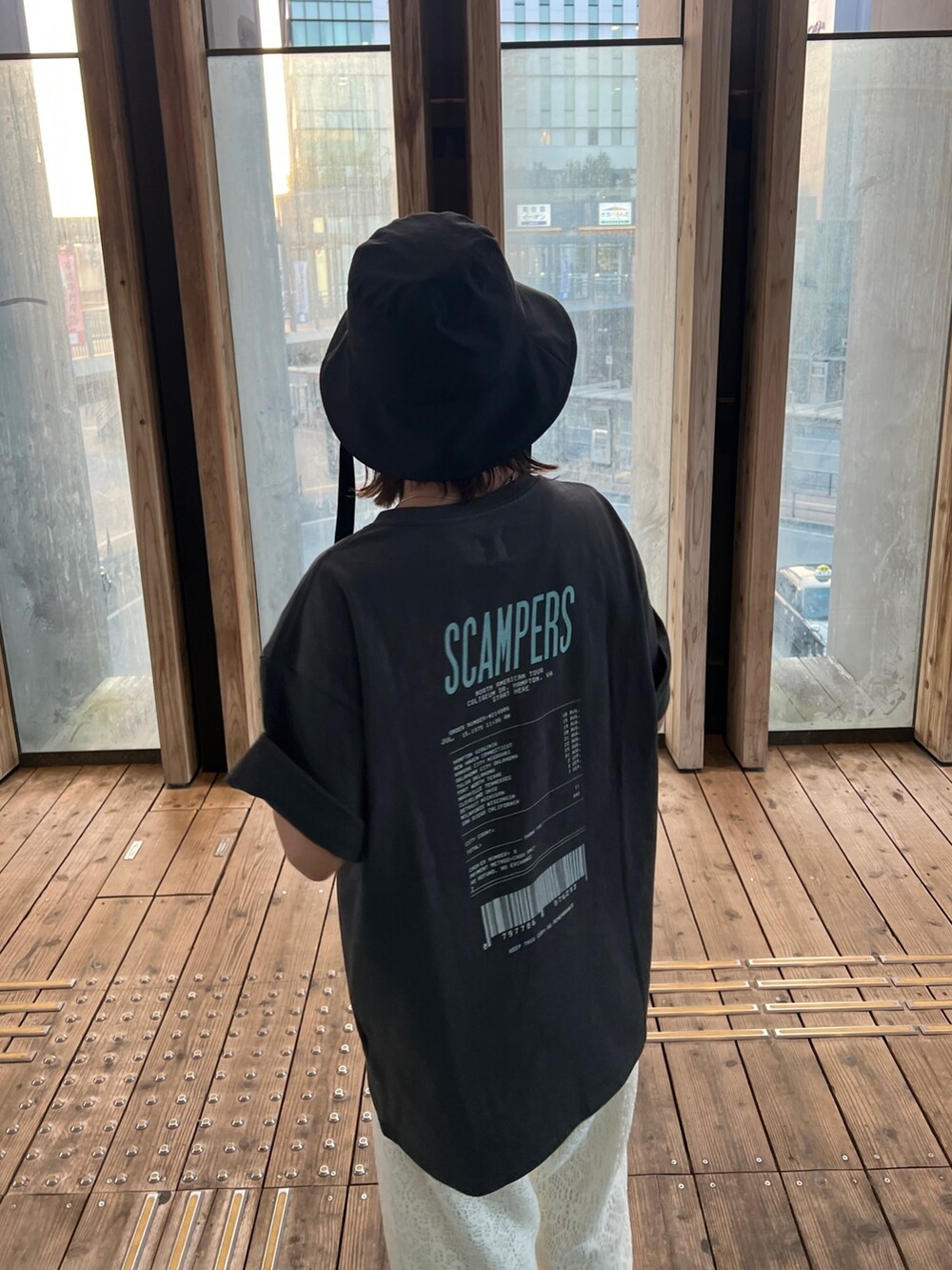 グレー系のTシャツ/カットソー、ホワイト系のその他パンツ、ブラック系のサンダルを着用したレディースの春コーディネートの6枚目の写真