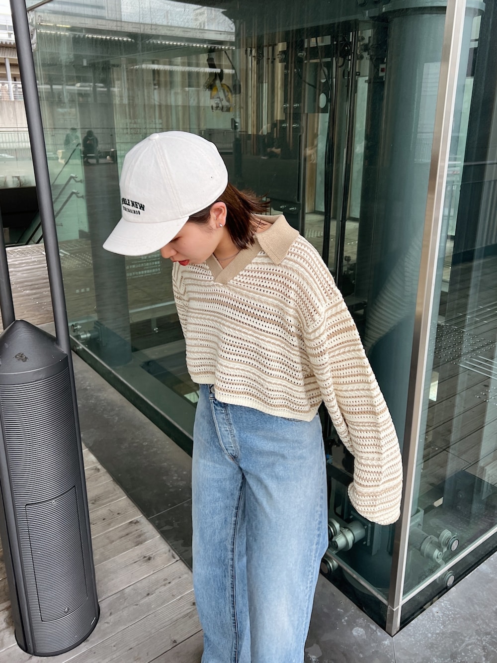 ベージュ系のニット/セーター、ブルー系のデニムパンツ、ホワイト系のサンダルを着用したレディースの春コーディネートの8枚目の写真