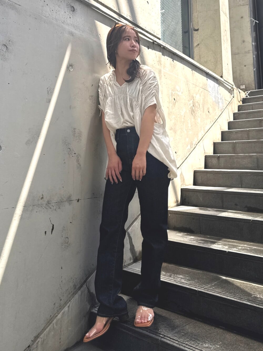 ブルー系のデニムパンツ、その他のサンダル、ホワイト系のシャツ/ブラウスを着用したレディースの春コーディネートの2枚目の写真
