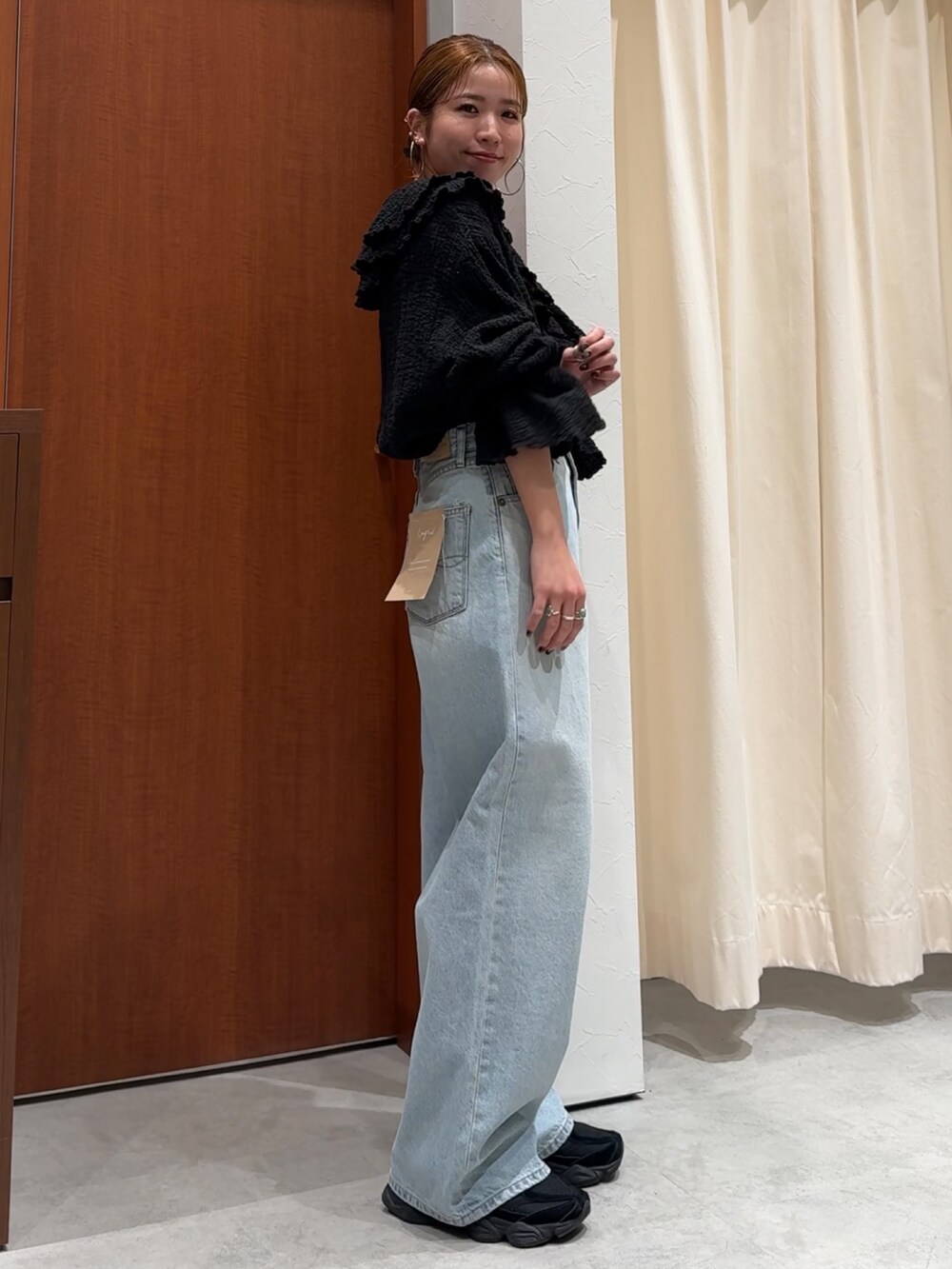 ブラック系のシャツ/ブラウス、ブルー系のデニムパンツを着用したレディースの春コーディネートの3枚目の写真