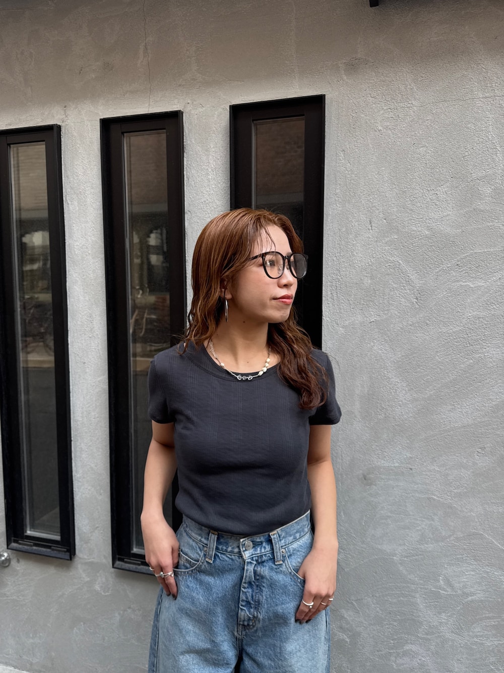 ブルー系のデニムパンツ、ブルー系のスニーカー、グレー系のTシャツ/カットソーを着用したレディースの春コーディネートの6枚目の写真