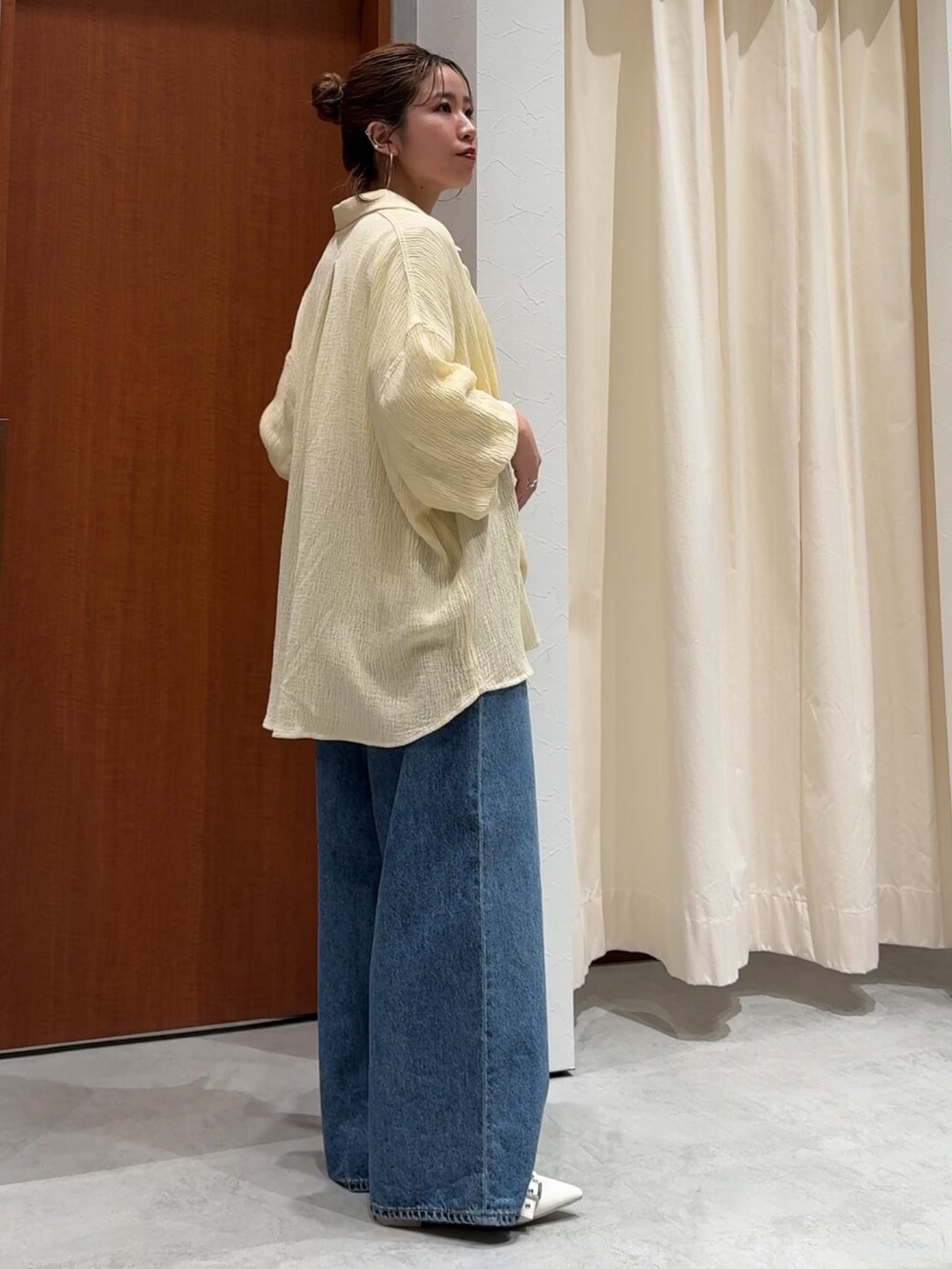 ブルー系のデニムパンツ、ホワイト系のTシャツ/カットソー、イエロー系のシャツ/ブラウスを着用したレディースの春コーディネートの3枚目の写真