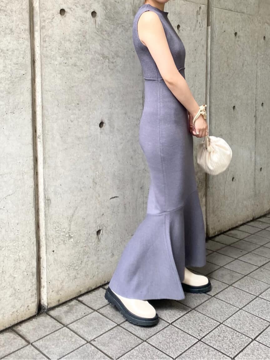 ホワイト系のハンドバッグ、ブルー系のワンピース、ホワイト系のブーツを着用したレディースの秋コーディネートの4枚目の写真