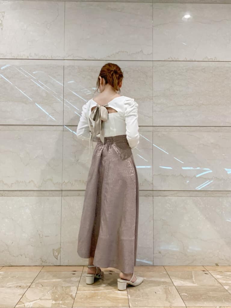 ホワイト系のTシャツ/カットソー、ピンク系のスカート、ホワイト系のショルダーバッグを着用したレディースの冬コーディネートの2枚目の写真