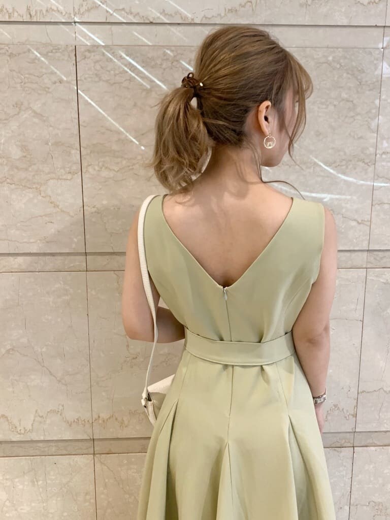 グリーン系のワンピース、ブラウン系のサンダル、ホワイト系のシャツ/ブラウスを着用したレディースの春コーディネートの5枚目の写真