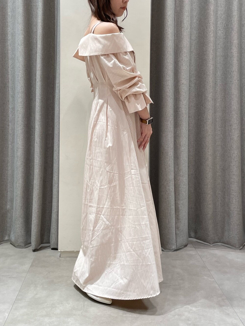 ピンク系のシャツワンピース、ホワイト系のパンプスを着用したレディースの春コーディネートの2枚目の写真