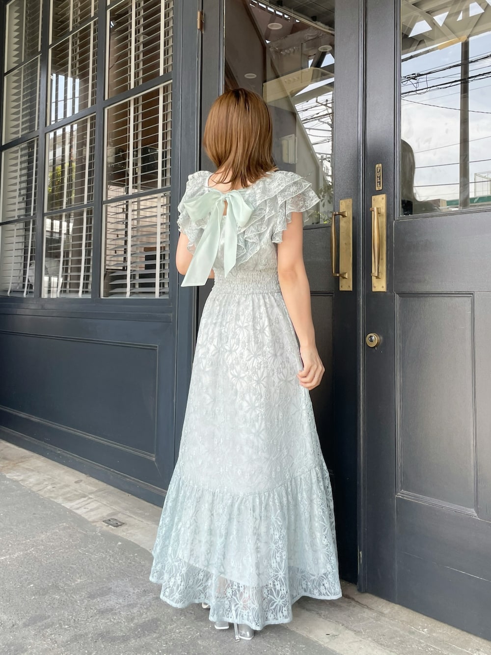 グリーン系のワンピース、シルバー系のローファーを着用したレディースの春コーディネートの2枚目の写真