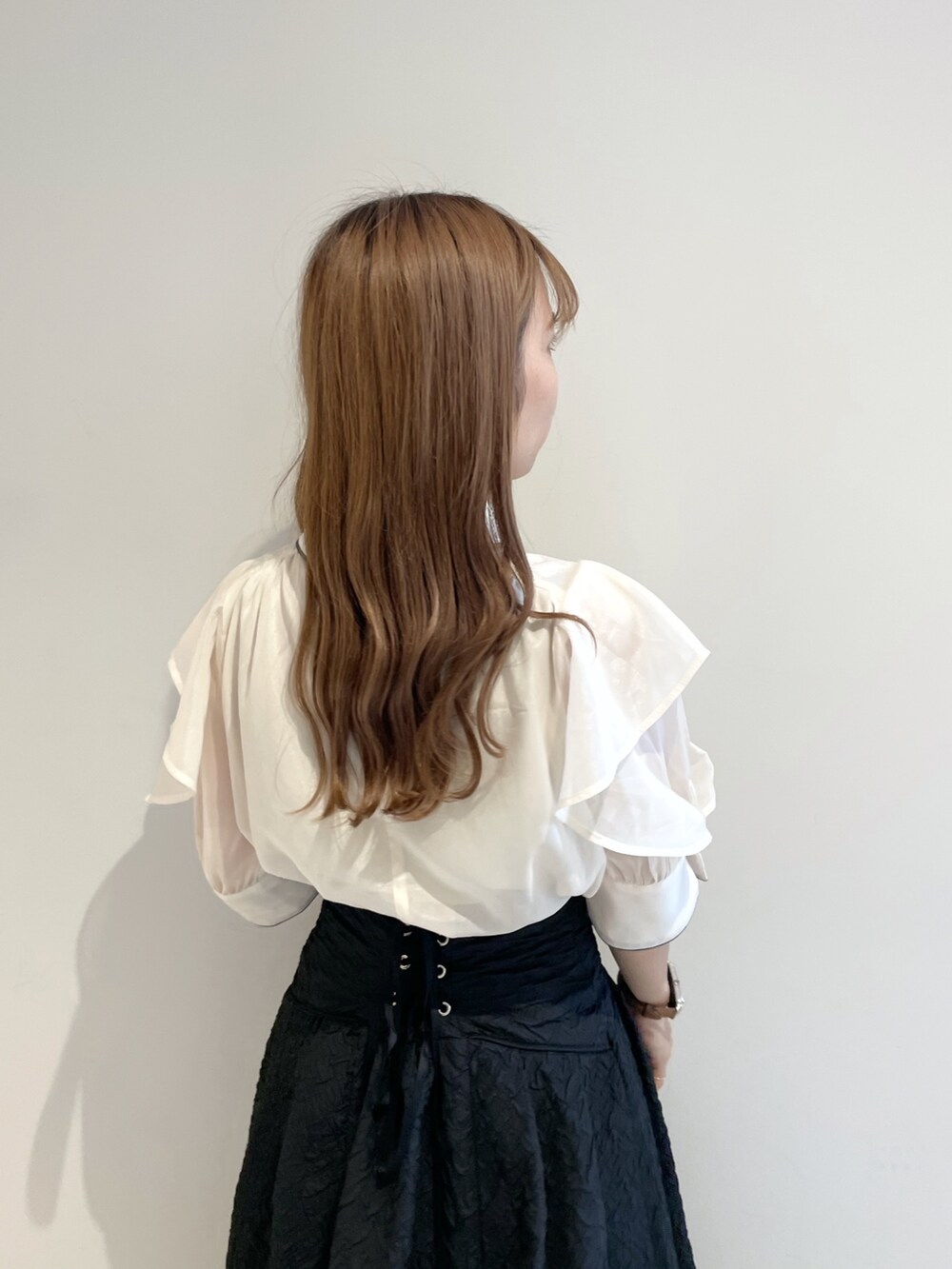 ホワイト系のシャツ/ブラウス、ブラック系のスカート、ブラック系のパンプスを着用したレディースの夏コーディネートの6枚目の写真