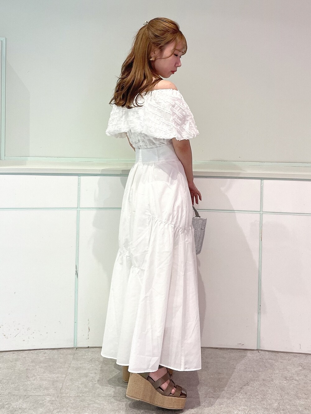 ホワイト系のシャツ/ブラウス、ホワイト系のスカート、ブラウン系のサンダルを着用したレディースの夏コーディネートの5枚目の写真