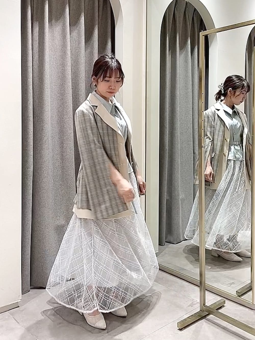 ブルー系のワンピース、その他のテーラードジャケット、ホワイト系のパンプスを着用したレディースの冬コーディネートの4枚目の写真