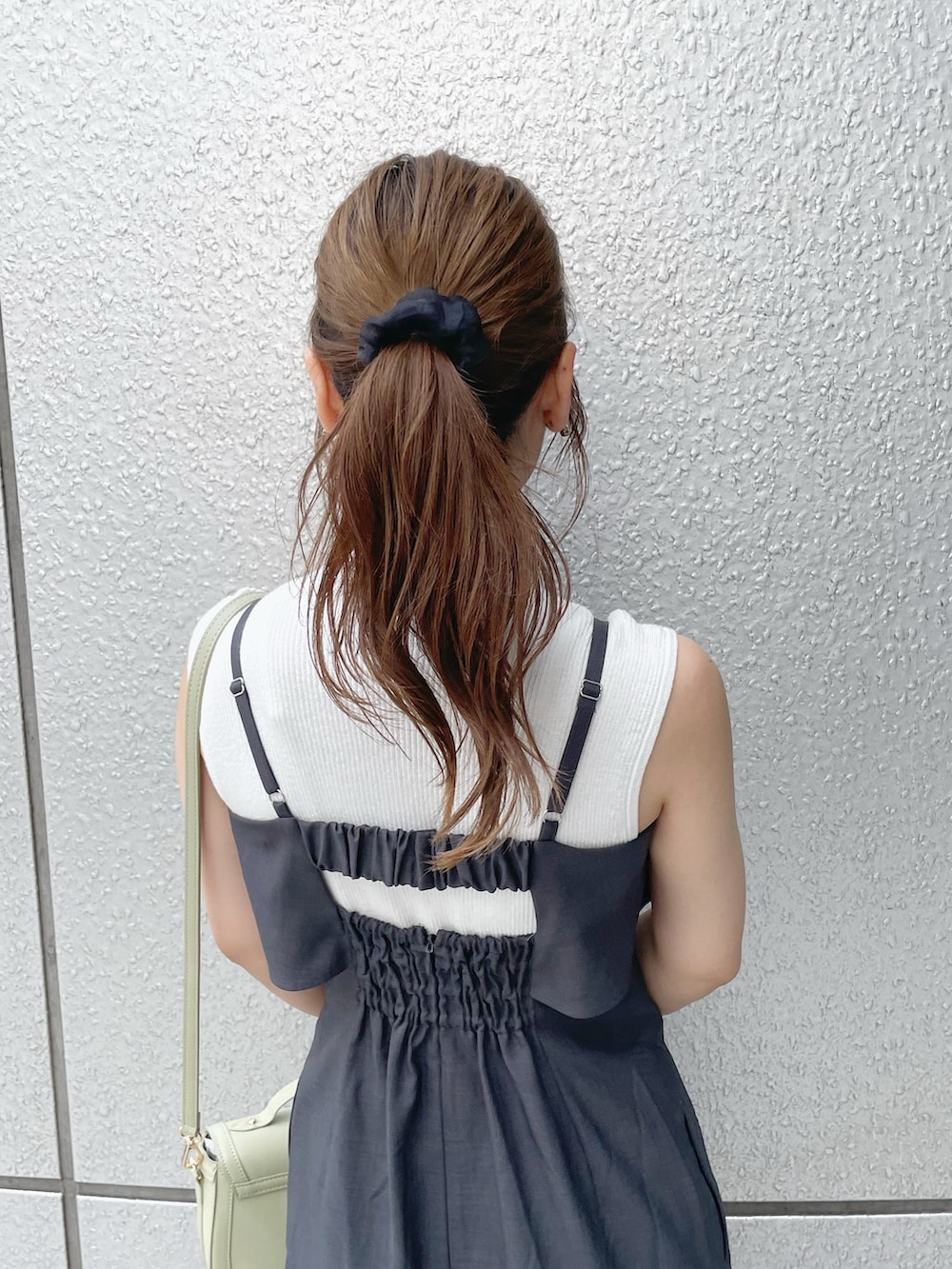 ホワイト系のニット/セーター、グレー系のワンピース、ブラック系のサンダルを着用したレディースの夏コーディネートの9枚目の写真