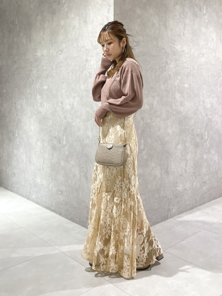 ピンク系のニット/セーター、ベージュ系のスカート、ベージュ系のスカートを着用したレディースの秋コーディネートの2枚目の写真