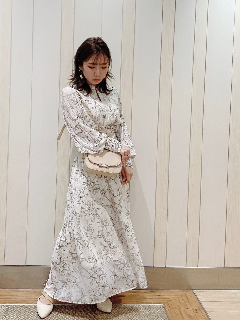 ホワイト系のワンピース、ベージュ系のパンプス、ベージュ系のショルダーバッグを着用したレディースの冬コーディネートの8枚目の写真