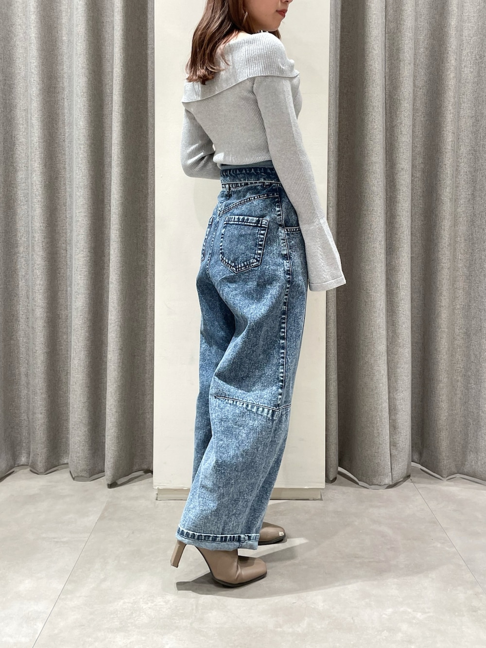 その他のデニムパンツ、シルバー系のニット/セーター、ベージュ系のブーツを着用したレディースの冬コーディネートの2枚目の写真