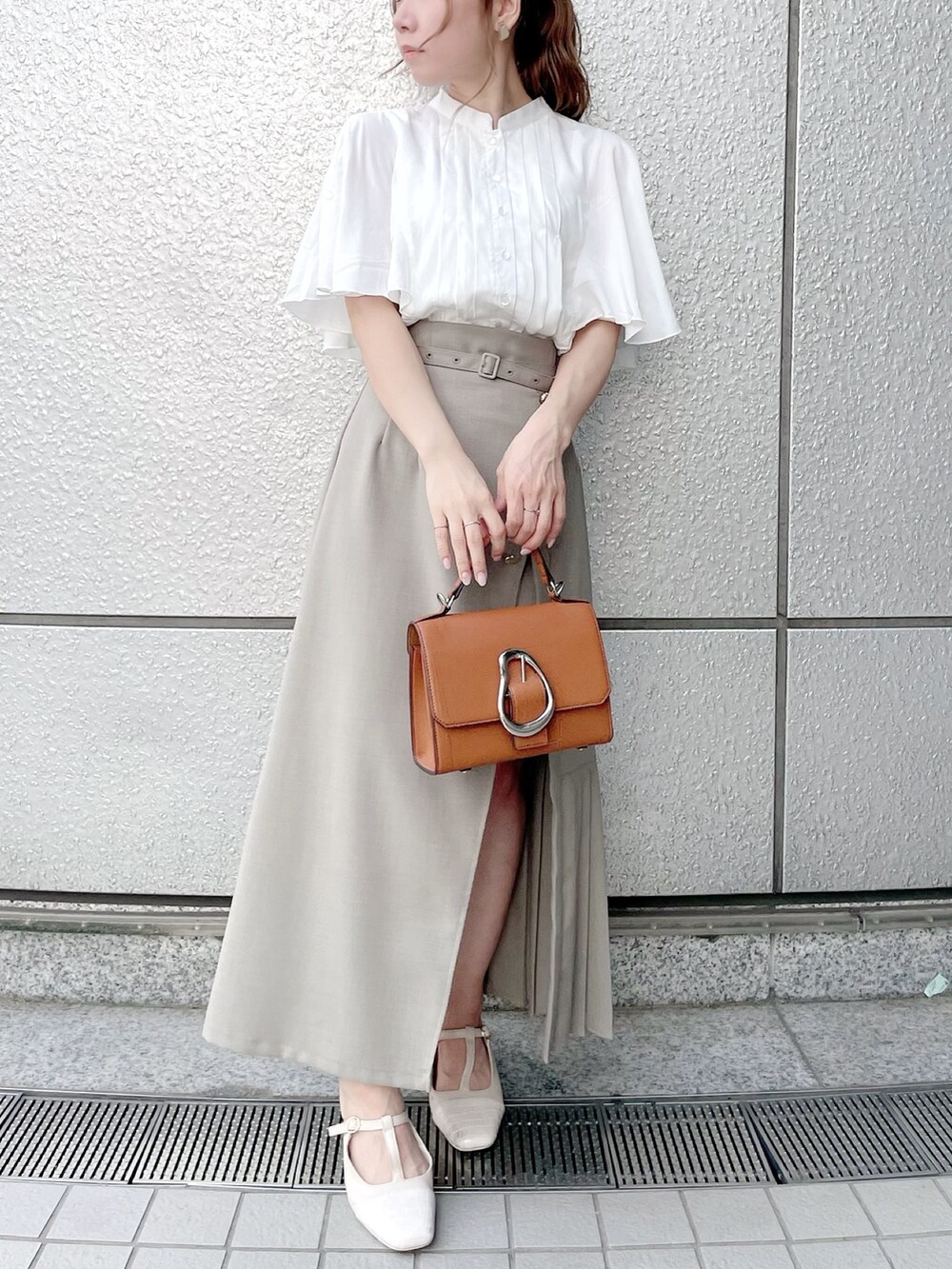 ホワイト系のシャツ/ブラウス、グリーン系のスカート、ホワイト系のパンプスを着用したレディースの春コーディネートの3枚目の写真