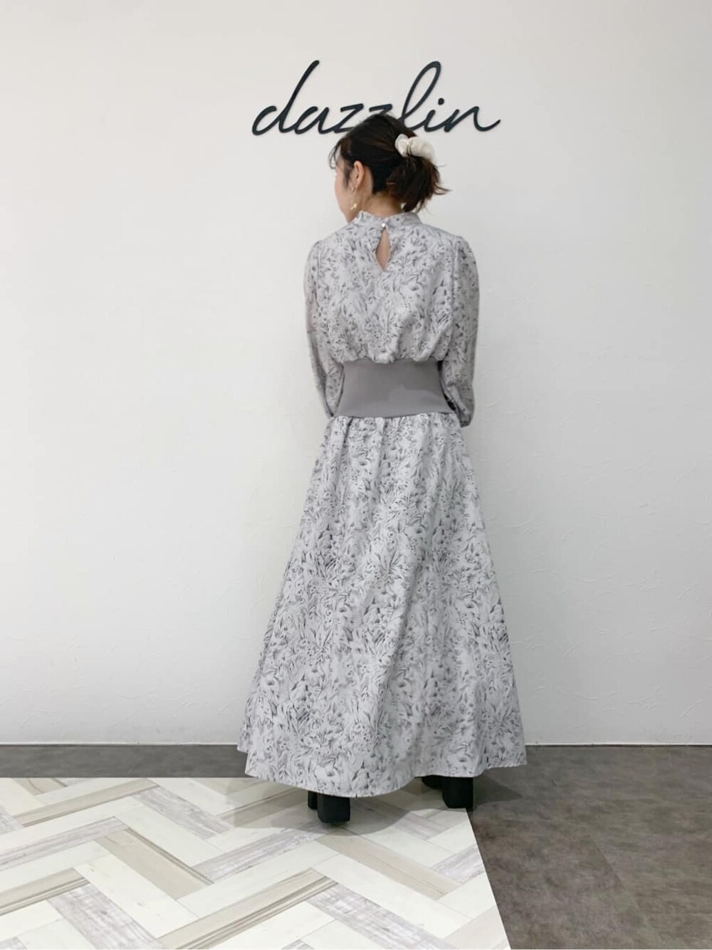 グレー系のブーツ、ブルー系のチェスターコート、グレー系のワンピースを着用したレディースの冬コーディネートの6枚目の写真