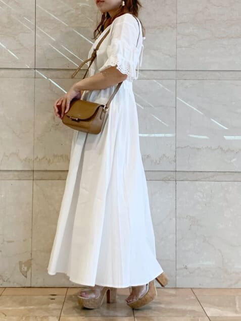 ホワイト系のワンピース、ブラウン系のショルダーバッグを着用したレディースの春コーディネートの2枚目の写真