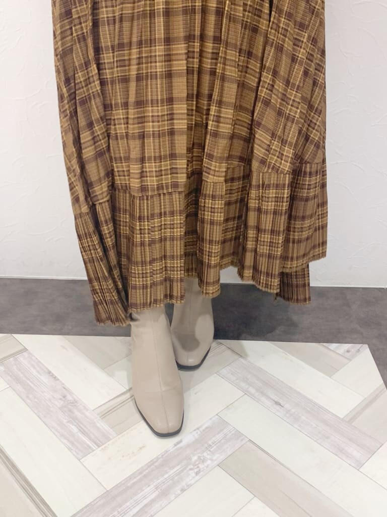 ホワイト系のシャツ/ブラウス、ブラウン系のスカート、ベージュ系のブーツを着用したレディースの夏コーディネートの9枚目の写真