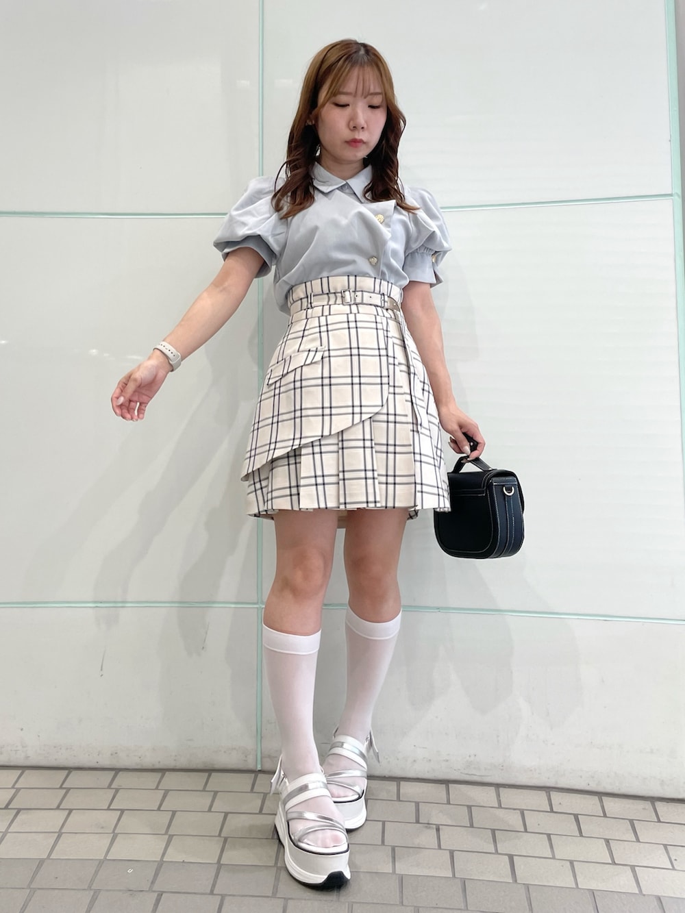 グレー系のシャツ/ブラウス、ベージュ系のスカート、ブラック系のハンドバッグを着用したレディースの夏コーディネートの2枚目の写真