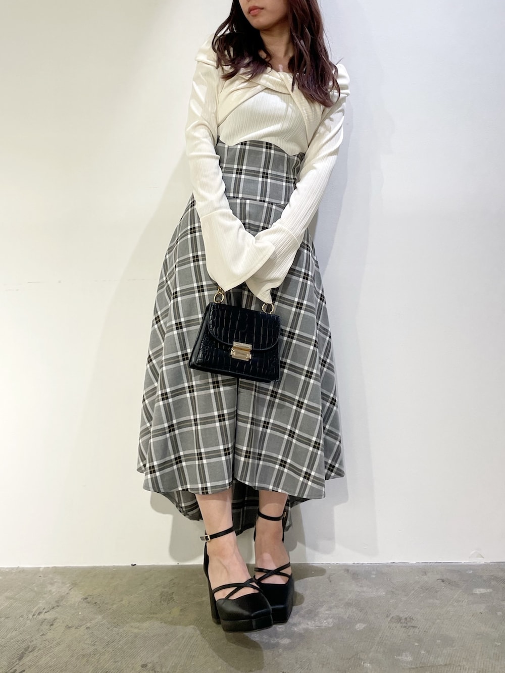 ホワイト系のワンピース、ブラック系のパンプスを着用したレディースの秋コーディネートの4枚目の写真