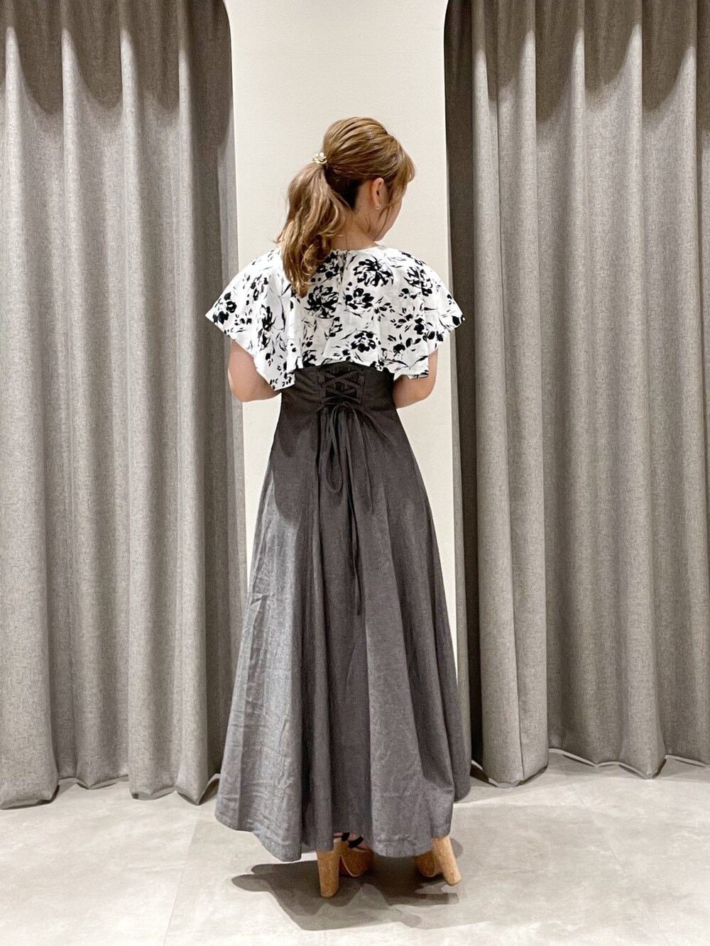 ブラック系のワンピース、ブラック系のハンドバッグ、ブラック系のサンダルを着用したレディースの夏コーディネートの3枚目の写真