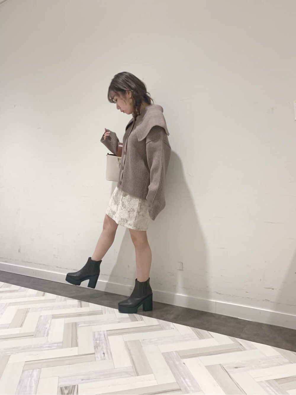 ブラウン系のブーツ、ベージュ系のニット/セーター、ベージュ系のスカートを着用したレディースの秋コーディネートの5枚目の写真