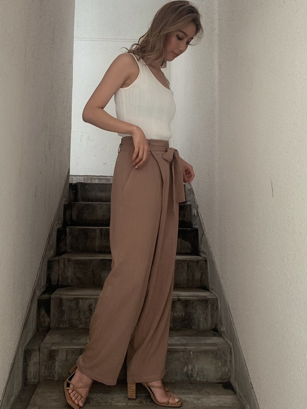 ベージュ系のその他パンツ、ホワイト系のタンクトップを着用したレディースの春コーディネートの2枚目の写真