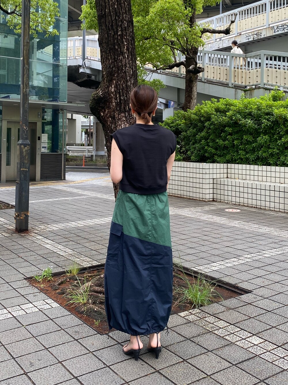 ブルー系のスカート、ブラック系のタンクトップを着用したレディースの夏コーディネートの4枚目の写真